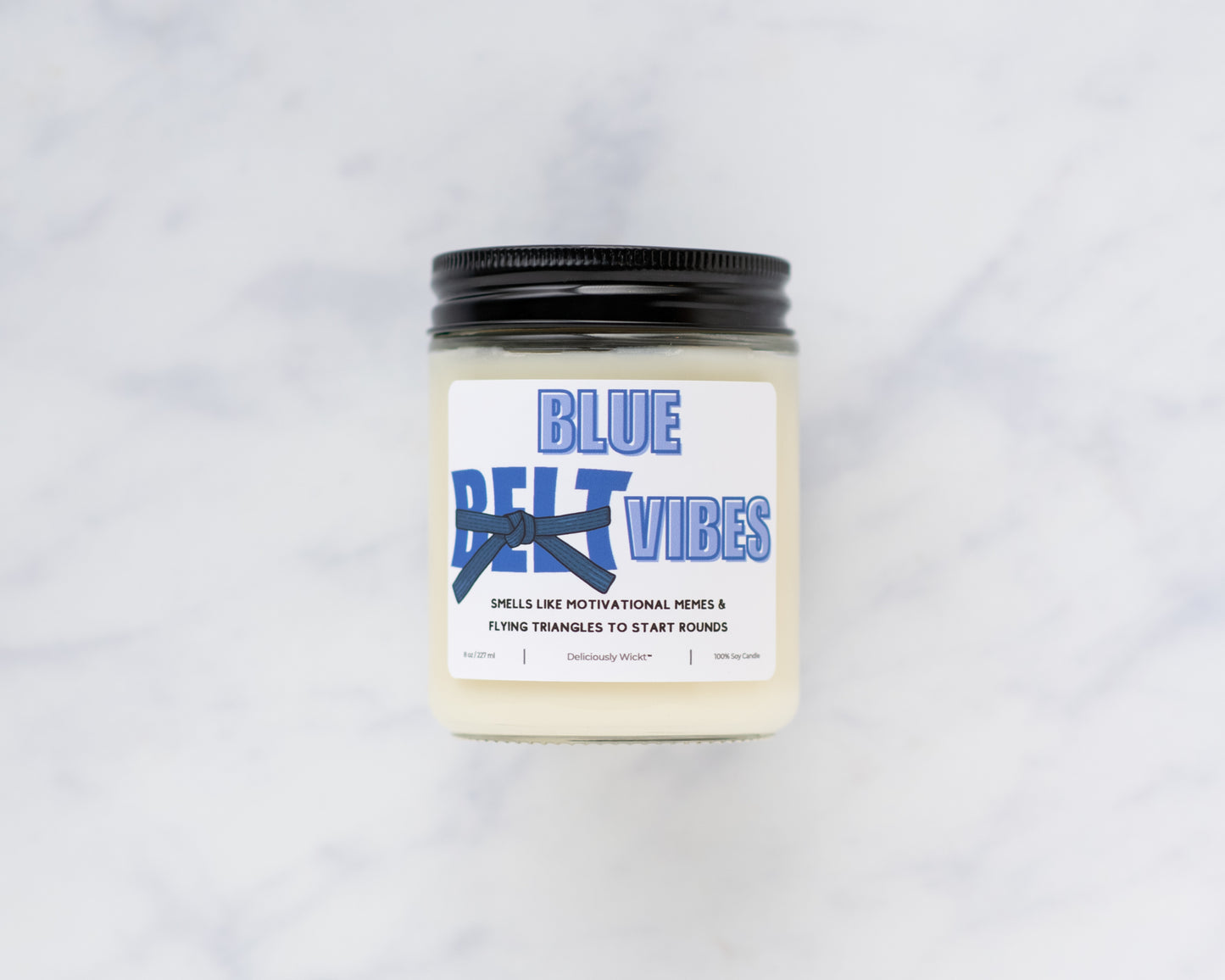 Blue Belt Vibes Jiu-Jitsu soy candle on a marble background