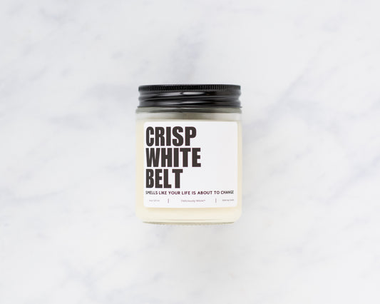 Crisp White Belt Jiu-Jitsu soy candle displayed on a marble background