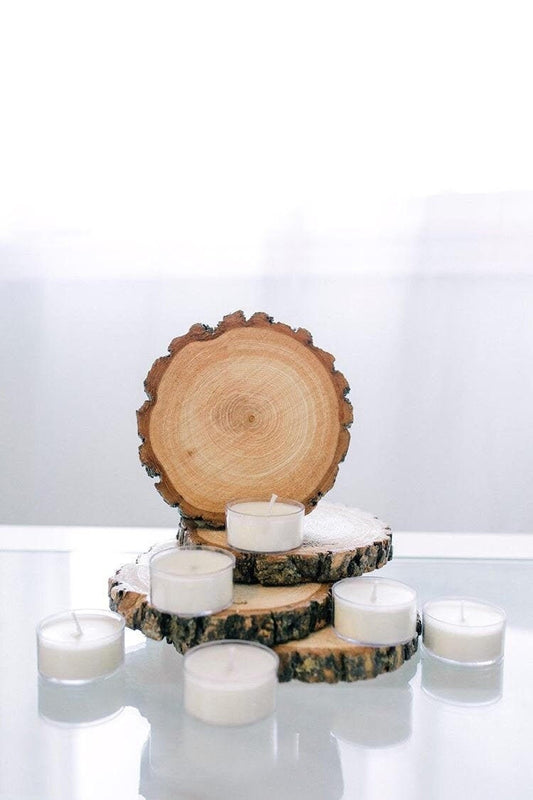 Unscented soy tea lights arranged with natural wood slices