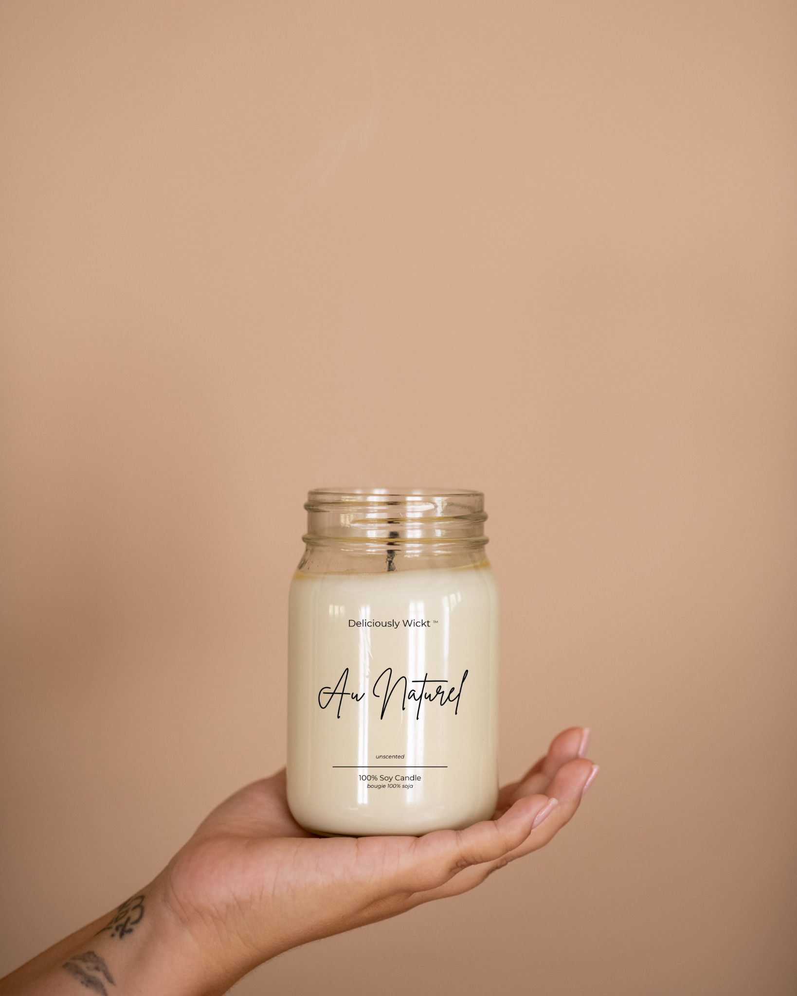 Au Naturel unscented soy candle in a clear mason jar held in one hand