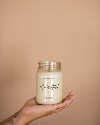 Au Naturel unscented soy candle in a clear mason jar held in one hand