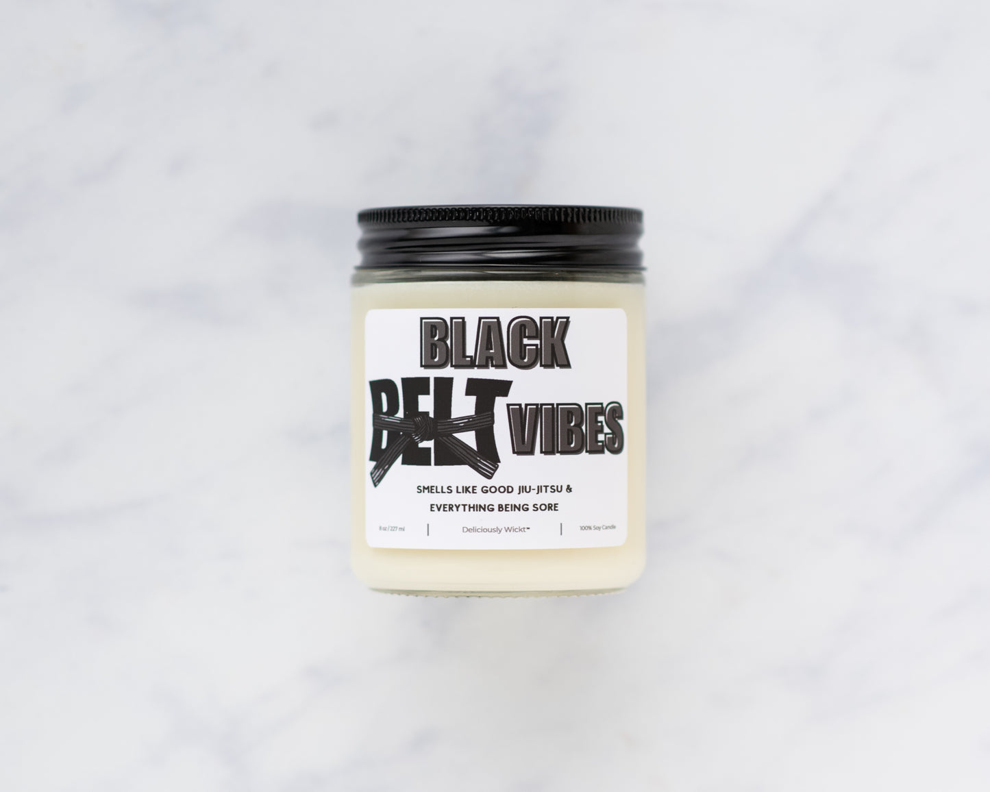 Black Belt Vibes Jiu-Jitsu soy candle on a marble background