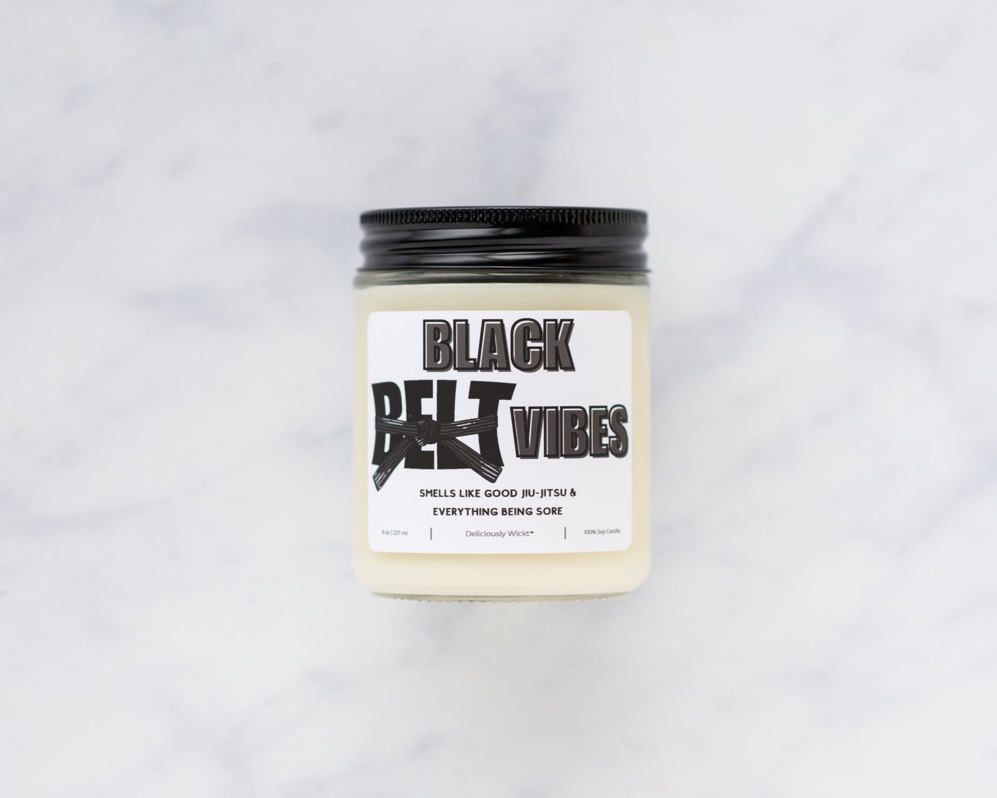 Black Belt Vibes Jiu-Jitsu soy candle on a marble background