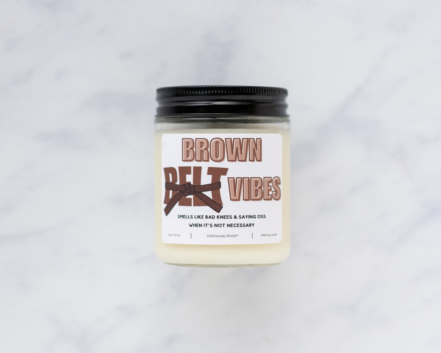 Brown Belt Vibes Jiu-Jitsu soy candle on a marble background
