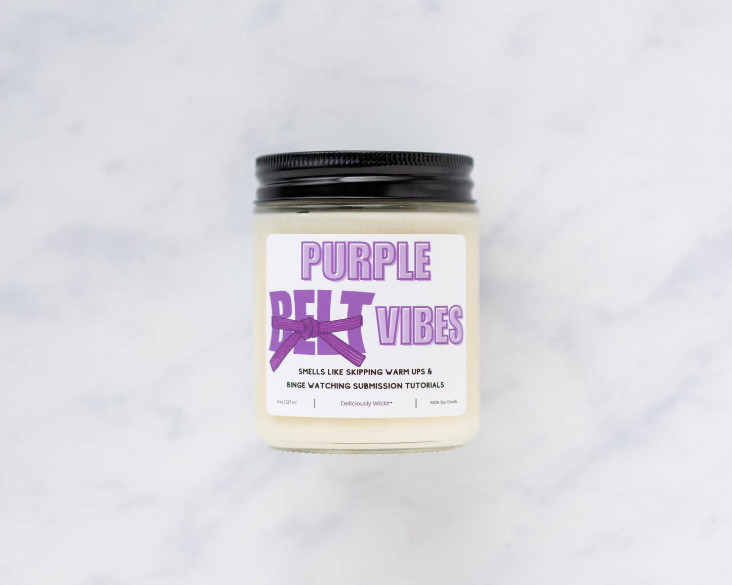 Purple Belt Vibes Jiu-Jitsu soy candle on a marble background