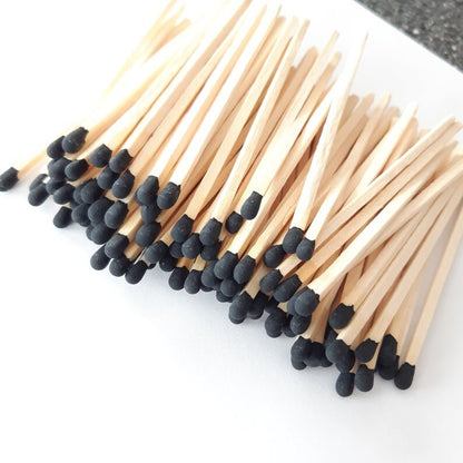 Close-up of Deliciously Wickt black-tipped long stick safety match refills.