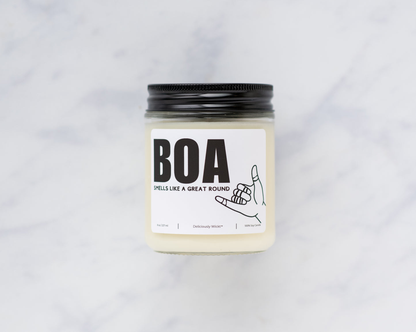 BOA Jiu-Jitsu soy candle with “Smells like a great round” label on a marble background