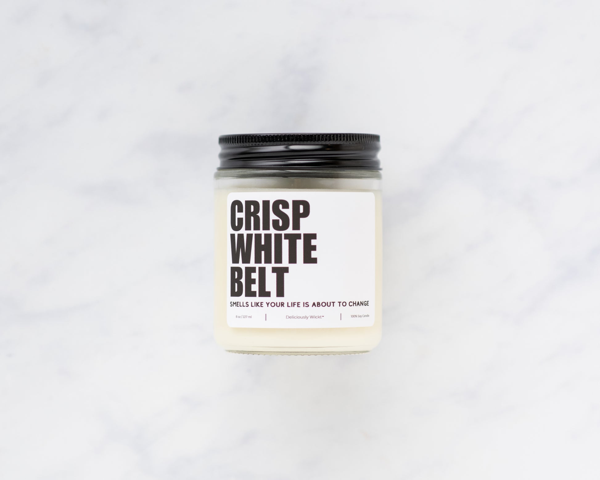 Crisp White Belt Jiu-Jitsu soy candle displayed on a marble background
