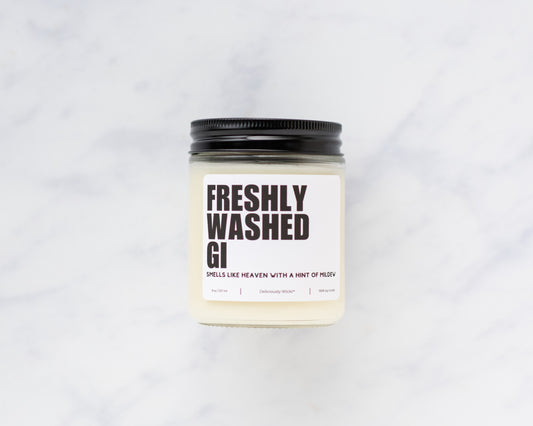 Freshly Washed Gi Jiu-Jitsu soy candle displayed on a marble background