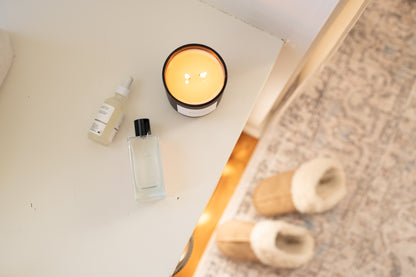 Deliciously Wickt Hope/Love/Joy 17 oz soy candle photographed from above on a light surface beside a rose gold tray.