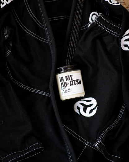 Deliciously Wickt In My Jiu-Jitsu Era 8 oz soy candle styled with black Jiu-Jitsu gi.