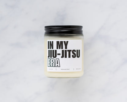 Deliciously Wickt In My Jiu-Jitsu Era 8 oz soy candle and product box displayed on a light background.