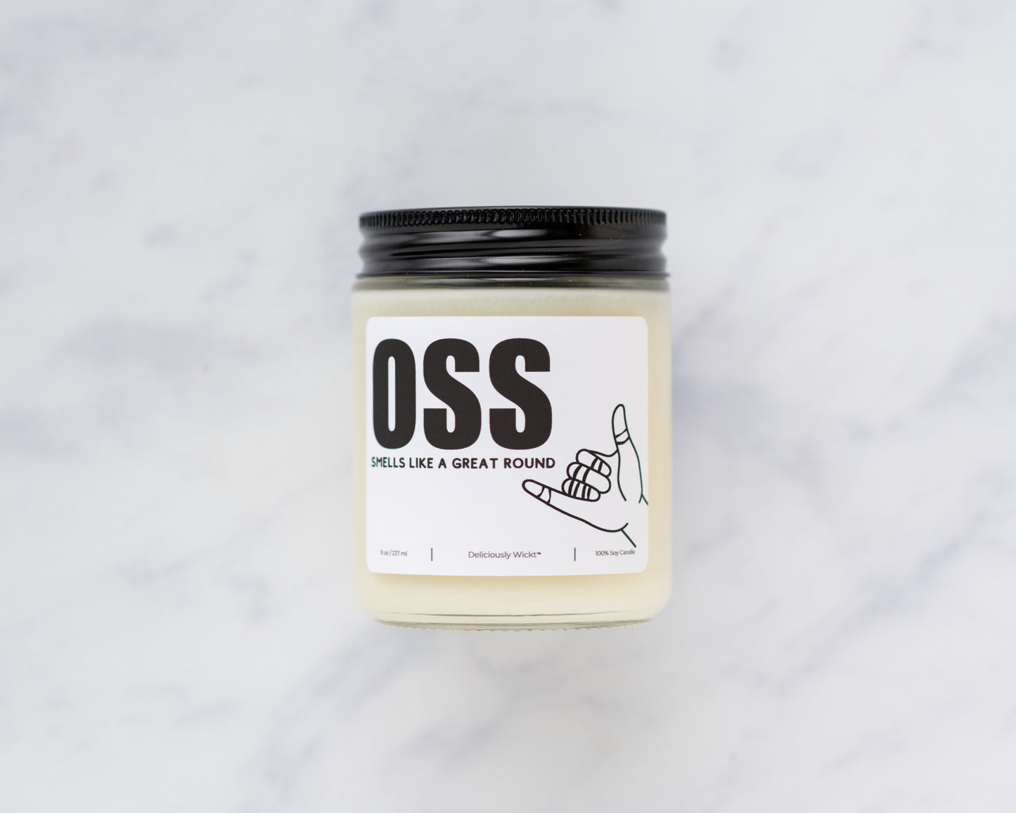 OSS Jiu-Jitsu soy candle with “Smells like a great round” label on a marble background