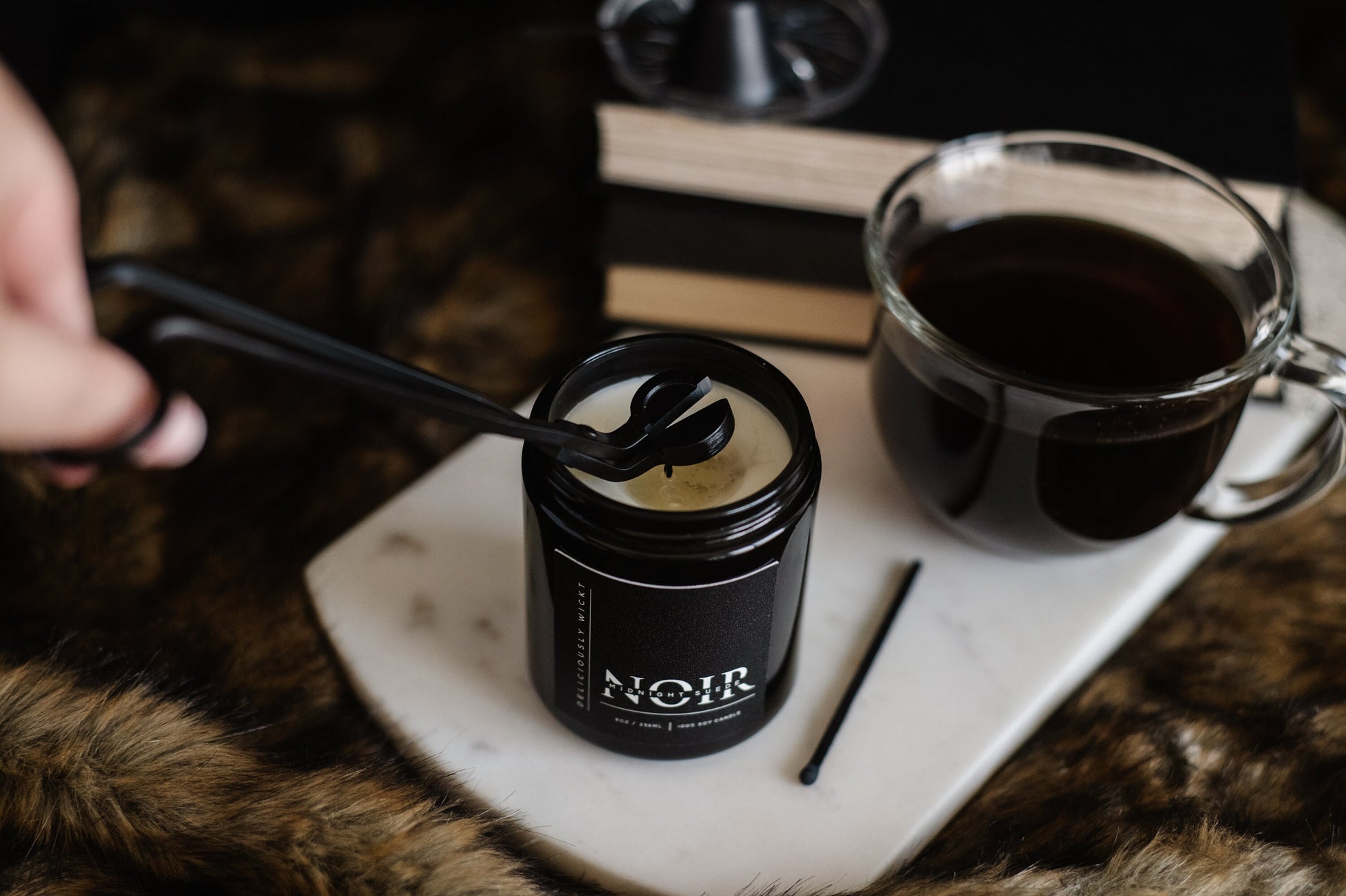 Palo Santo NOIR soy candle styled with a mug and candle accessories