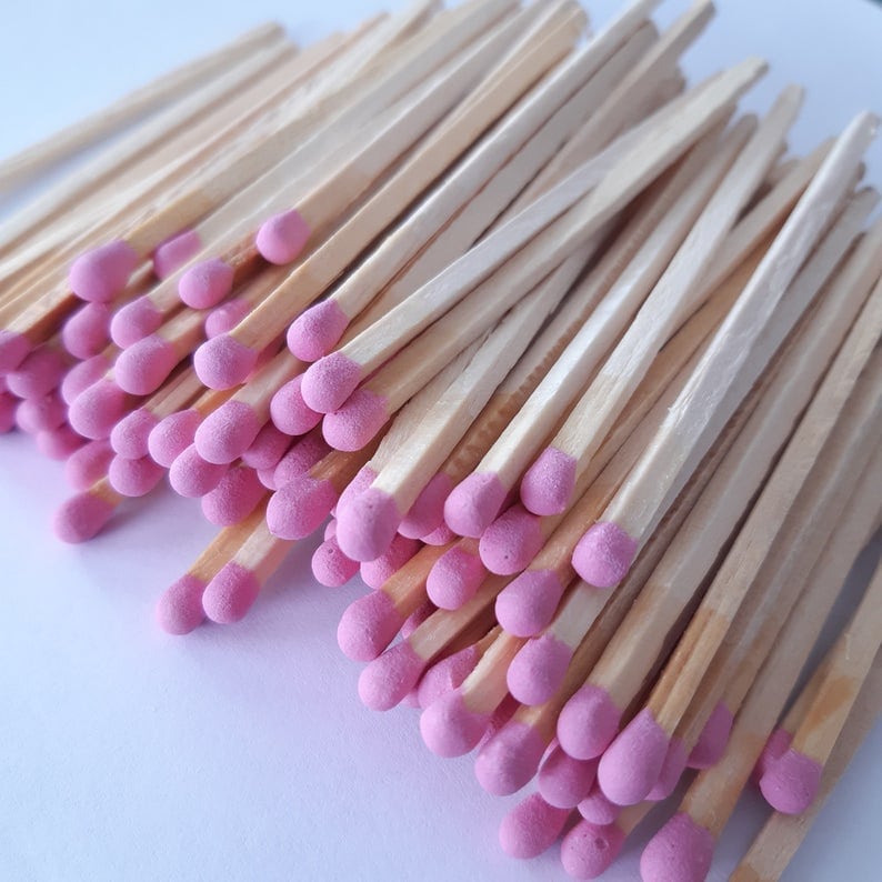 Close-up of Deliciously Wickt pink-tipped long stick safety match refills.