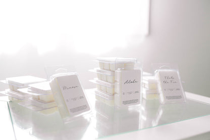 Assorted Deliciously Wickt scented soy wax melt packages displayed together on a light surface.