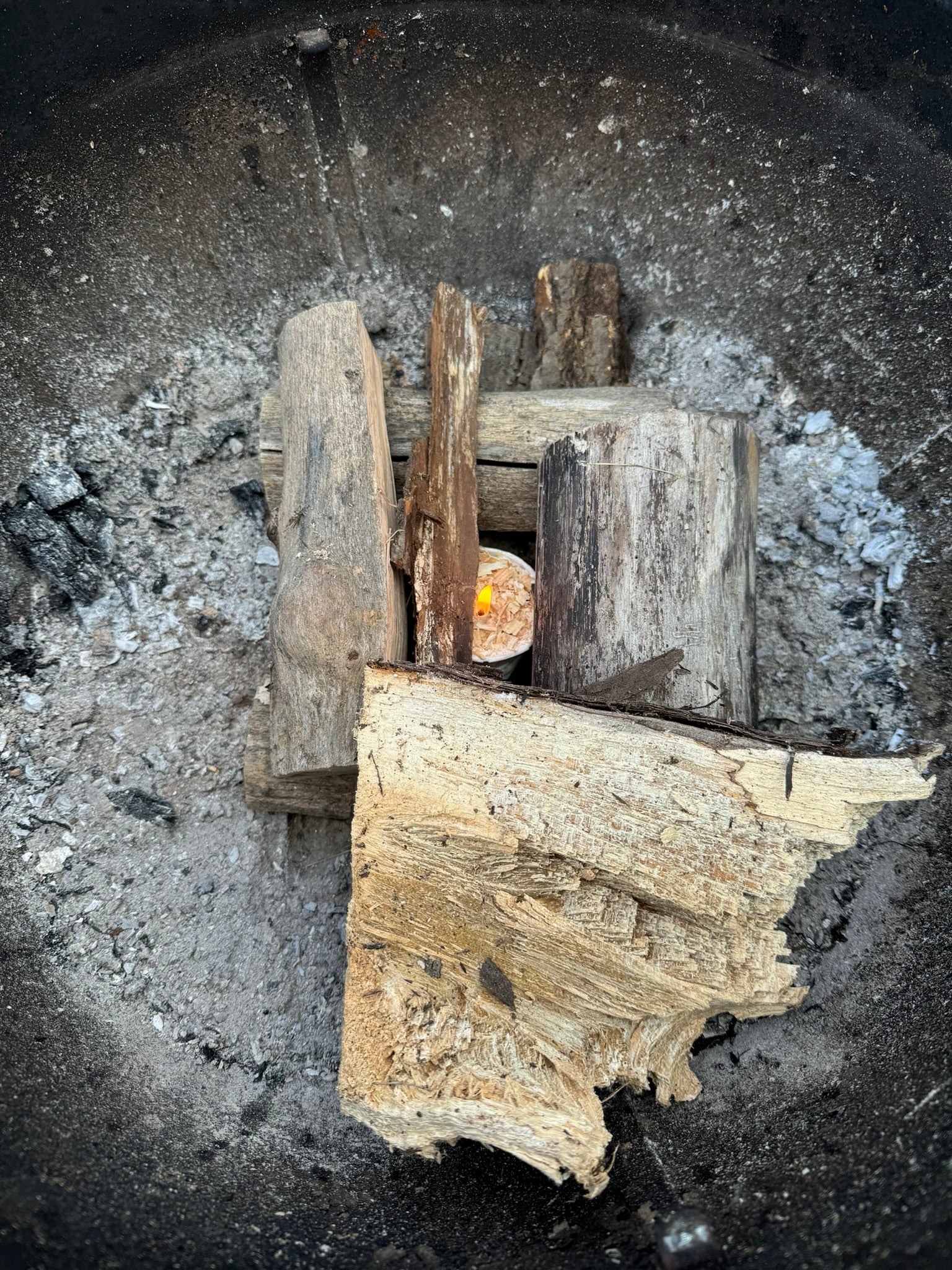 Deliciously Wickt Torcht firestarter pod positioned between split wood ready to be lit.