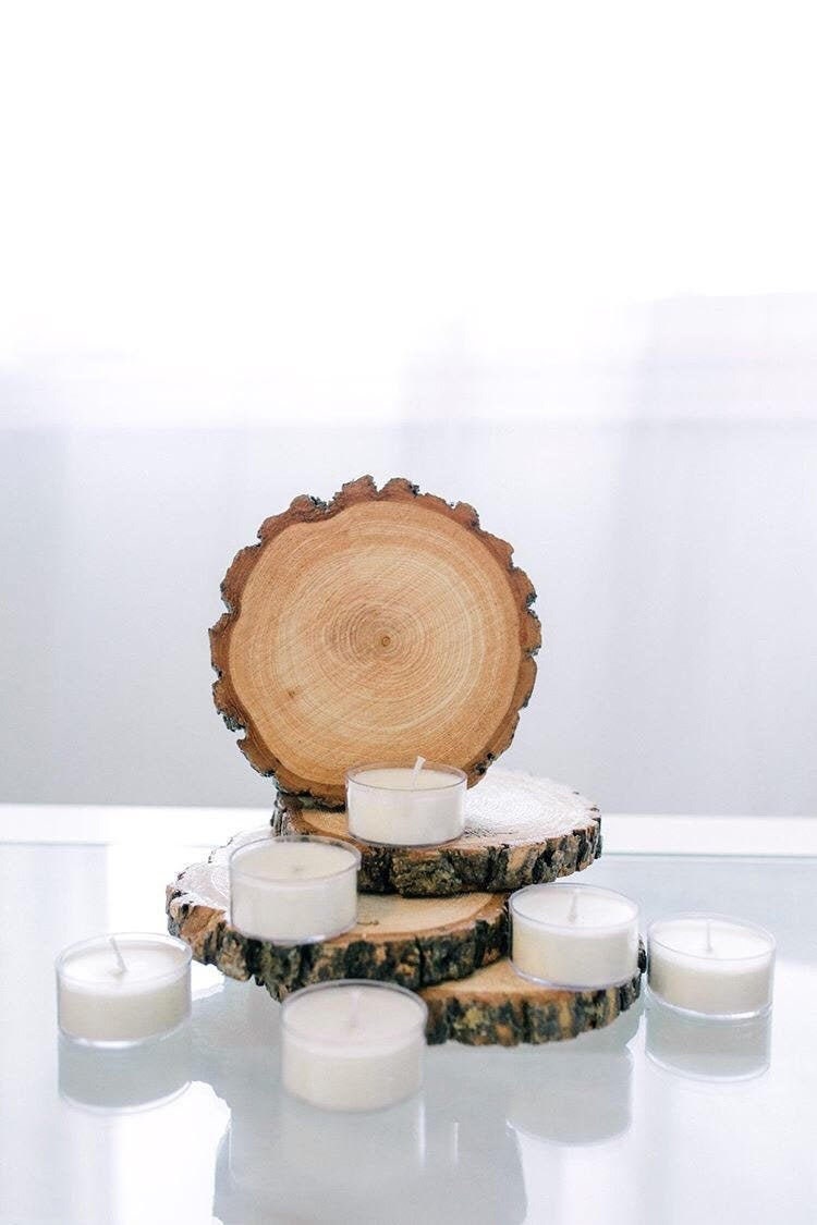 Unscented soy tea lights arranged with natural wood slices