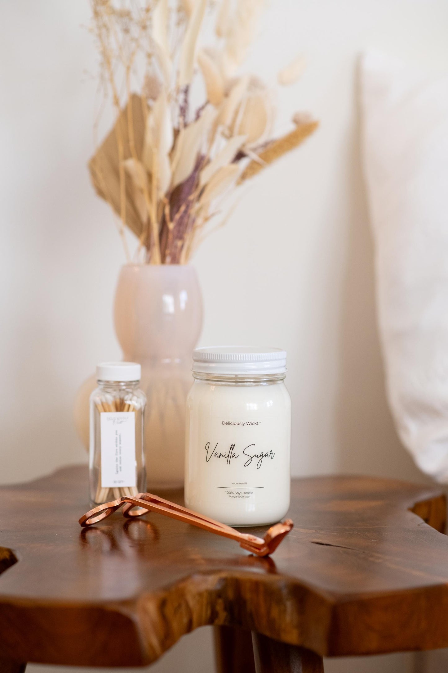 Deliciously Wickt Vanilla Sugar 16 oz mason jar soy candle on a wooden table with warm neutral decor.